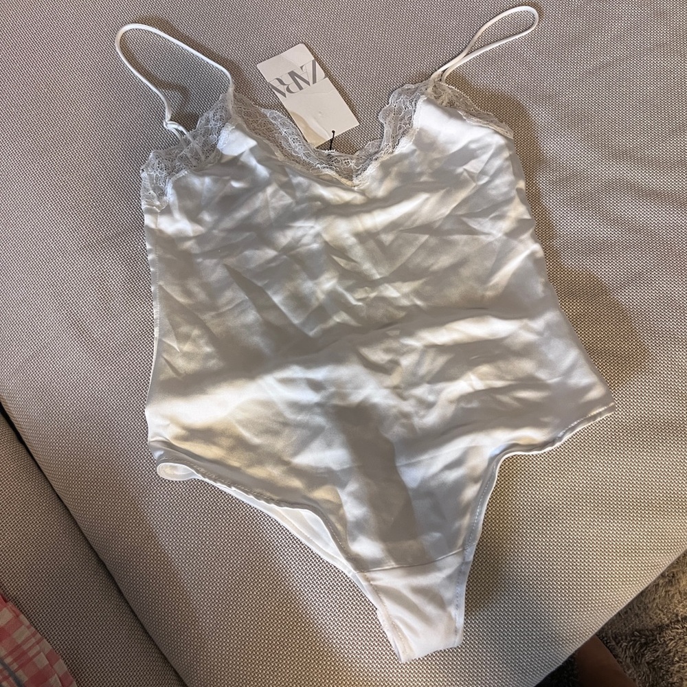Brand new Zara white satin bodysuit with lace trim.